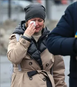  ?? Picture: AP Photo/Vitaly Smolnikov ?? Above, a woman cries outside the Crocus City Hall, on the western edge of Moscow