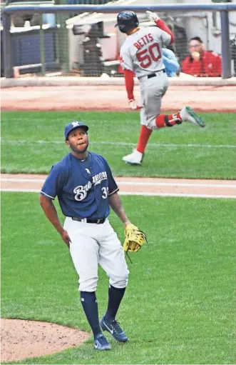  ?? BENNY SIEU / USA TODAY SPORTS ?? Brewers pitcher Neftali Feliz reacts after giving up a three-run home run to Boston’s Mookie Betts.