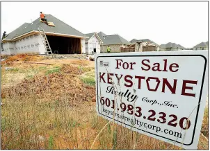  ?? AP ?? Workers install a roof in June on a new house in Brandon, Miss. New-home sales fell in July, missing estimates, after an upward revision for June took those sales to the highest level since 2007.