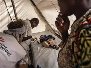  ?? PICTURE: MARTA SOSZYNSKA ?? A mother watches as her child is examined by MSF nurses for cholera symptoms in Katana.