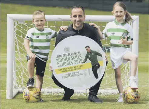  ??  ?? 2 John Kennedy promotes Celtic’s summer soccer schools yesterday with little helpers Max Murray, left, and Orla Currie.