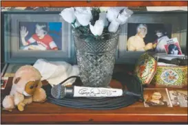  ?? (AP/John Minchillo) ?? A signed microphone by The Who’s Roger Daltrey on display in a memorial cabinet at the Finneytown High School secondary campus in Finneytown, Ohio.