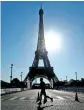  ?? REUTERS ?? A runner passes the Eiffel Tower during sunrise in Paris, France.