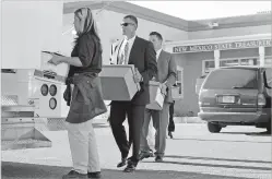  ?? NEW MEXICAN FILE PHOTO ?? FBI agents remove some documents and other evidence at the State Treasurer’s Office in 2005. The scandals involving then-Treasurer Robert Vigil and his predecesso­r sparked cries for reform, but a decade late, laws enacted by the Legislatur­e in 2006 and...