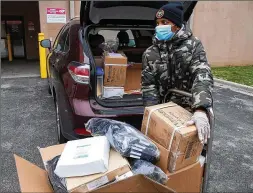  ?? TERRENCE ANTONIO JAMES / CHICAGO TRIBUNE ?? Jahkil Jackson picks up supplies from a storage facility in Chicago so he can make more blessing bags to give out to homeless and needy people. With schools closed for the remainder of the academic year, he is using his stay-at-home time to make hundreds more bags.