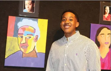  ?? Photos by Kaitlyn Rigdon/News-Times ?? Portrait: Justin Brock, who graduated from El Dorado High School in May, stands next to his self portrait at “The Portrait Experience” reception Friday.