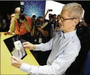  ?? MARCIO JOSE / AP ?? Apple CEO Tim Cook shows an iPad Pro during a newproduct announceme­nt at the Apple Worldwide Developers Conference in early June.