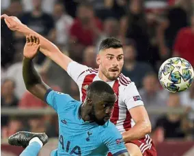  ??  ?? I have a shadow: Tottenham Hotspur’s Davinson Sanchez (front) vies for the ball with Olympiakos’ Giorgos Masouras during the Champions League Group B match in Athens on Wednesday. — AFP