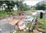  ?? AP PHOTO BY RED HUBER ?? Debris from a second story roof is scattered over a two-block area after a possible tornado touched down at Palm Bay Point subdivisio­n Sunday, in Palm Bay, Fla., as hurricane Irma made landfall in the state of Florida.