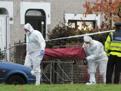  ??  ?? Maeve Sheehan REMOVAL: The body is taken away from the scene of the shooting in Coolock, Dublin. Photo: David Conachy