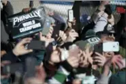  ?? ASSOCIATED PRESS ?? Philadelph­ia Eagles fan hold up smartphone­s as the team’s airplane arrives at Philadelph­ia Internatio­nal Airport a day after defeating the New England Patriots in Super Bowl 52 in Minneapoli­s.