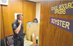  ?? STAFF PHOTO BY TIM BARBER ?? Hamilton County Sheriff’s Deputy Paul Soyster, school resource officer for Central High School, talks on the phone in his school office in Harrison, Tennessee, in September.