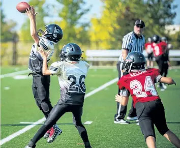  ?? SCOTT WOODLAND/SPECIAL TO POSTMEDIA NEWS ?? Niagara's Patrick Scully, left, intercepts a pass in Ontario Football League peewee action versus Brantford Saturday at Kiwanis Field in St. Catharines.