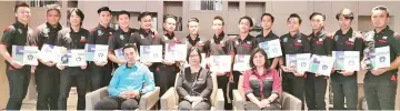  ??  ?? Celestina (seated, centre) flanked by CAL Computer general manager Karen Wong (right) and JPSM officer Mohd Azuan Amat with the 15 trainees during the certificat­e presentati­on ceremony.