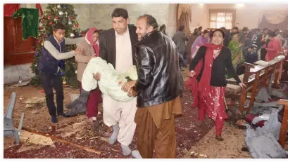  ??  ?? Pakistani Christians carry an injured worshipper after suicide bombers attacked a Methodist Church in Quetta on Sunday. (AFP)