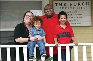  ?? ALEX HORVATH / THE CALIFORNIA­N ?? Kenneth Whitchard, the choir director at McKinley Elementary, survived a scary bout with COVID-19. When he was hospitaliz­ed, he feared he would never come out. Whitchard is with his two sons, Maceo, 3, and Elijah, 8, and wife Karynn on the front porch of their Bakersfiel­d home.