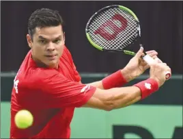  ?? The Canadian Press ?? Milos Raonic, of Canada, returns a shot to Thiemo De Bakker, of the Netherland­s, during Davis Cup action in Toronto on Friday. Raonic won in straight sets 6-3, 6-2, 6-2.