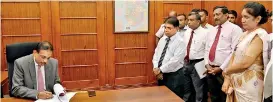  ??  ?? New Finance Secretary S.R. Attygalle assumes duty