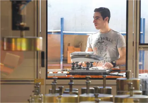  ?? — AFP ?? PRIVAS, France: A worker tests a scale at the world leader in the weighing industry, Precia Molen company, on March 15, 2017 in southern France.