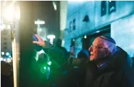  ?? The Des Moines Register via AP ?? Sen. Bernie Sanders, I-Vt., lights a menorah Dec. 29, 2019, during the “Chanukah on Ice” celebratio­n at the Brenton Skating Plaza in Des Moines, Iowa.