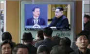  ?? AHN YOUNG-JOON — THE ASSOCIATED PRESS ?? People watch a TV screen showing images of North Korean leader Kim Jong Un and South Korean President Moon Jaein, left, at the Seoul Railway Station in Seoul, South Korea, on Wednesday.