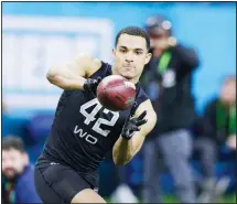  ??  ?? In this file photo, Navy wide receiver Malcolm Perry runs a drill at the NFL football scouting combine in Indianapol­is. Perry, drafted by the Miami Dolphins, will be able to turn pro in 2020 thanks to a policy change initiated by
President Donald Trump. (AP)