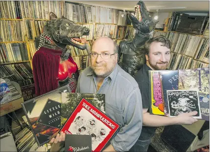  ??  ?? Neptoon Records owner Rob Frith, left, with his son Ben, show off some vinyl albums in the basement of their store in Vancouver. Rob Frith reports that sales of CDs as well as vinyl are increasing.