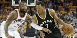  ?? TONY DEJAK — THE ASSOCIATED PRESS ?? Toronto Raptors’ Kyle Lowry (7) drives past Cleveland Cavaliers’ Kyrie Irving (2) during the first half in Game 2 of a second-round NBA basketball playoff series Wednesday in Cleveland. The Cavaliers won 125-103.