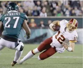  ?? MICHAEL PEREZ/AP ?? Redskins quarterbac­k Colt McCoy injured his leg when he connected with the Eagles’ Malcolm Jenkins on this slide in the second quarter Monday night.