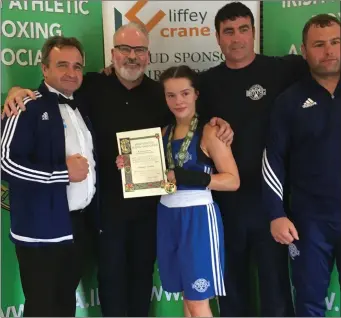  ??  ?? Enniskerry Boxing Club’s Daina Moorehouse ceelbrates her fifth All Ireland title with her dedicated team of coaches at the National Stadium.