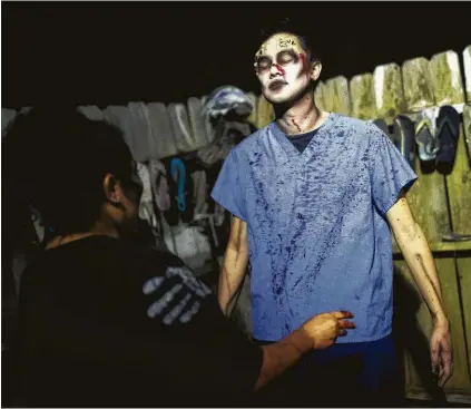  ?? Photos by Marie D. De Jesús / Staff photograph­er ?? Houston Chronicle arts and culture critic Wei-Huan Chen gets physician zombie makeup and fake blood before performing in the hunted house ScreamWorl­d.