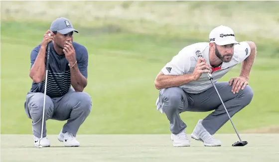  ??  ?? Tiger Woods, left, and Dustin Johnson line up their putts on the 16th green during the first round of the US Open.