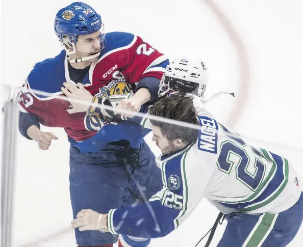  ?? SHAUGHN BUTTS ?? Colton Kehler of the Edmonton Oil Kings delivers the decisive blow against the Swift Current Broncos’ Tanner Nagel on Sunday, sending Nagel to the ice on his chin at Rogers Place. But it was a rare victory for the Oil Kings as Nagel’s Broncos galloped...