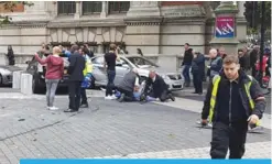  ??  ?? LONDON: A man is being restrained alongside vehicles on Exhibition Road between the Victoria and Albert (V&A) Museum and the Natural History Museum yesterday following an incident in South Kensington.