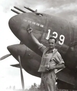  ??  ?? Above: On the afternoon of June 16, 1943, Capt. Jim Shubin of the 339th Fighter Squadron stands by his P-38F #129 on Fighter Two Airstrip on Guadalcana­l. Shubin holds two 20mm shells casings in a “V” signifying his downing of five Japanese Zeros...