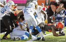  ?? RON SCHWANE/ASSOCIATED PRESS ?? Cleveland Browns running back Nick Chubb dives in for a touchdown past Los Angeles Chargers safety Nasir Adderley during the first half Sunday. Chubb ran for 134 yards and two touchdowns in the Browns’ loss.