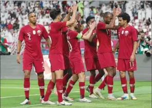  ??  ?? Qatar players clap for the ‘2019 Asian Player of the Year’ Akram Afif after he scored the opening goal against UAE in the crucial Group A Gulf Cup match in Doha on Monday.