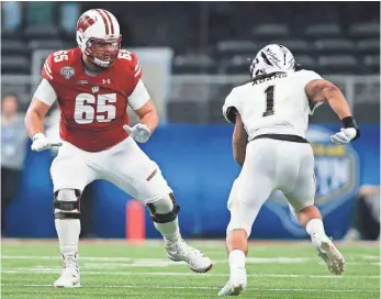  ?? TIM HEITMAN, USA TODAY SPORTS ?? Ryan Ramczyk, left, who played in a pro-style offense at Wisconsin and might be the most polished offensive tackle in this draft, had hip surgery in January.