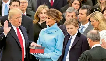  ?? — AP ?? Donald Trump is sworn in as the 45th United States president as his wife Melania Trump looks on in Washington on Friday. For a man who has never held a public office, this was the first time Mr Trump took a formal oath