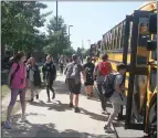  ?? MACOMB DAILY FILE PHOTO ?? Students board buses outside of Chippewa Valley Seneca Middle School in Macomb Township earlier this school year. With an expected order to close schools for the rest of the academic year it is unlikely students will return to Seneca and other Macomb schools.