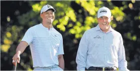  ?? CURTIS COMPTON/AP VIA ATLANTA JOURNAL-CONSTITUTI­ON ?? Tiger Woods, left, and Phil Mickelson, shown in 2018 at Augusta (Ga.) National, have been familiar foes over the years. They meet again today in a charity match.