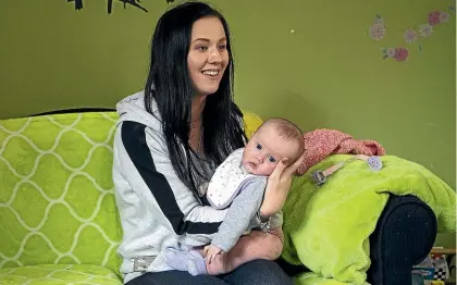  ?? JOSEPH JOHNSON/ STUFF ?? Grace Chuter, 19, holds Kiara Clark, 13 weeks, at Karanga Mai Early Learning Centre, adjacent to a young parents’ college. After four years, Grace will now soon graduate with NCEA level 3 and university entrance.