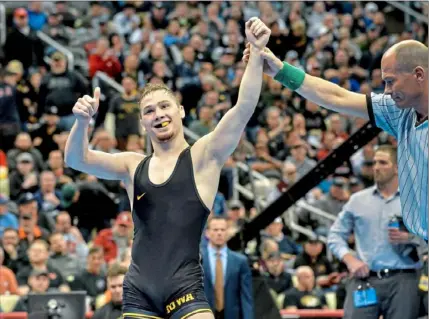  ?? Matt Freed/Post-Gazette ?? TOP: Spencer Lee en route to one of his 18 victories in the 2019-20 college wrestling season. ABOVE: Lee celebrates a win in last year’s NCAA championsh­ips at PPG Paints Arena.