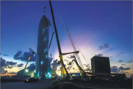  ?? Jonathan Newton Washington Post ?? CREWS WORK on the Starship prototype spacecraft in an area near Brownsvill­e, Texas, that Elon Musk would like to make a city.