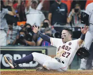  ?? Elsa Garrison Getty Images ?? JOSE ALTUVE EXULTS as he scores the winning run on Carlos Correa’s double in the bottom of the ninth inning. The throw beat Altuve, but Yankees catcher Gary Sanchez couldn’t handle it.