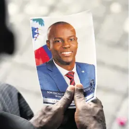  ?? MATIAS DELACROIX AP ?? A photo of late Haitian President Jovenel Moïse is held during his memorial ceremony at the National Pantheon Museum in Port-au-Prince, Haiti, on July 20, 2021. In a Miami case about Moïse’s slaying, a protective order bars defense attorneys from sharing ‘restricted material’ with anyone other than their clients, their legal staff and their experts.