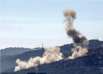  ?? — AFP photo ?? Smoke billows over hills near the southern Lebanese village of Odaisseh on the border with Israel during Israeli bombardmen­t, as fighting continues between Israel and the Palestinia­n militant group Hamas in Gaza.