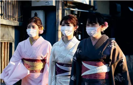  ?? GETTY IMAGES ?? Women dressed in Kimono costume wear face masks as a precaution during the coronaviru­s outbreak.