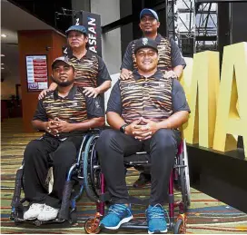  ??  ?? Ahmad Jafry Jamaludin (right) and his teammate Yuhaizam Yahya are among the archers spearheadi­ng Malaysia’s challenge in the Asean Para Games from Sept 17-23. With them are team manager Paul Leong (left, back) and national coach Marzuki Zakaria. —...