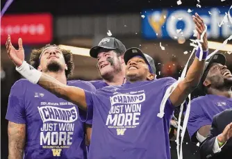  ?? Sara Diggins/associated Press ?? Washington quarterbac­k Michael Penix Jr., center, basks in the afterglow of the Huskies’ sixpoint victory over Texas on Monday night, their 10th consecutiv­e win by 10 points or fewer.